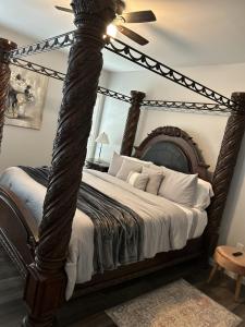 a bedroom with a large bed with a wooden frame at Favored Stay in Savannah