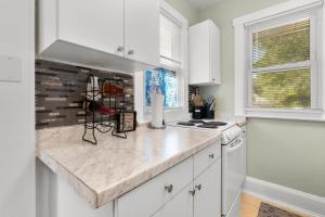 a kitchen with white cabinets and a counter top at Prime Location - Walk to Attractions - Sleeps up to 7 People in Tampa