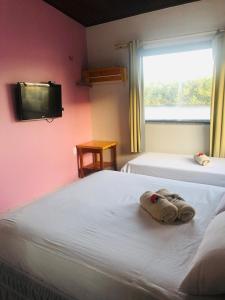 Säng eller sängar i ett rum på Lar da Preguiça: com vista para o rio preguiças