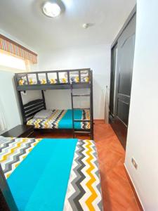 a room with two bunk beds in a room at شاليه للإيجار في بورتو مارينا الساحل الشمالي العلمين 34 in El Alamein