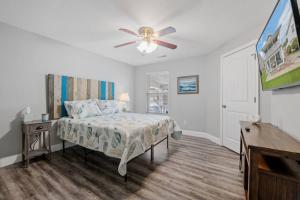 a bedroom with a bed and a ceiling fan at The Chesapeake St Retreat - Pet and Kid Friendly in Norfolk