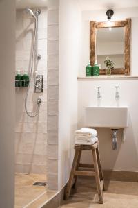 a bathroom with a sink and a shower at The Three Horseshoes in Burford