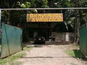a sign for a villas cacoco in a parking lot at Villas Cacao in Fortuna