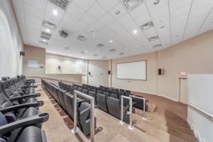 an empty lecture room with chairs and a whiteboard at Tidewater Beach Resort in Panama City Beach