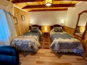 1 dormitorio con 2 camas en una habitación en Hostal Collins House, en Temuco