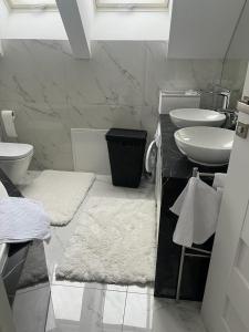 a bathroom with a sink and a toilet and towels at B-Apartment Vienna 12 in Vienna