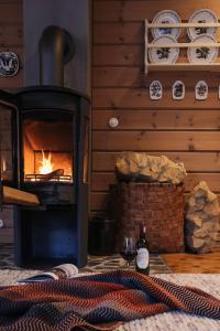 a fireplace in a room with a fire place at Maybua by May's in Reine