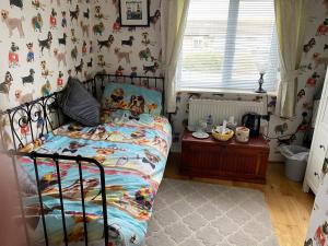 a childs bedroom with a bed and a table at 2 Friends Close in Kent