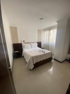 Rúm í herbergi á Hotel Yolima Real