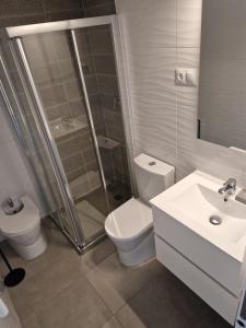 a bathroom with a shower and a toilet and a sink at Apartamento Calpe Beach in Calpe +8 photos