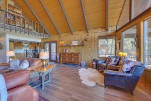 a living room with leather furniture in a house at Munds Park Cabin with Deck and Golf Course Views in Munds Park