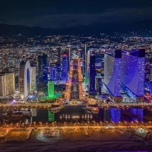 a view of a city at night at Rrrt in Batumi