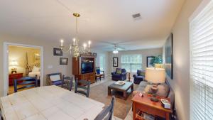 a living room with a table and a dining room at Spacious 3BR Villa Groups of Six in Pawleys Island in Pawleys Island