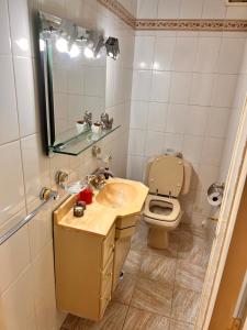 a bathroom with a sink and a toilet at Apartamento Belgrano in Buenos Aires +35 photos