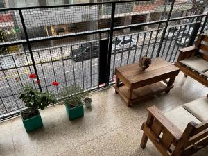 a cat sitting on a bench in front of a balcony at Apartamento Belgrano in Buenos Aires