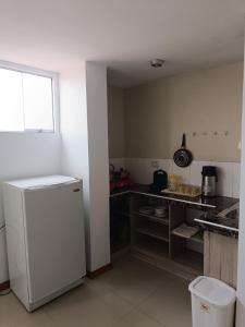 a kitchen with a counter and a refrigerator in it at Apartamento Mirador San Blas in Cusco