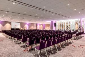 a conference room with chairs and a podium in the middle at Paris Marriott Rive Gauche Hotel & Conference Center in Paris