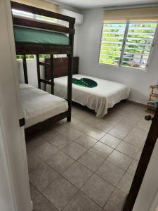 Letto o letti in una camera di Tropicoco Pool House Steps From The Beach