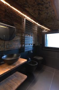 a bathroom with two toilets and a sink and a television at LaLux Venezia in Venice +35 photos