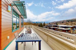 a blue bench sitting on the balcony of a building at Howelsen Panoramic Views in Steamboat Springs