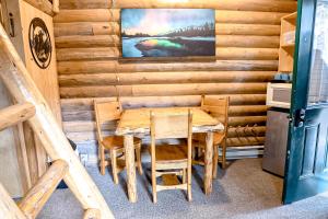 a dining room with a wooden table and chairs at Experience Montana Cabins - Cowboy #5 in Bigfork