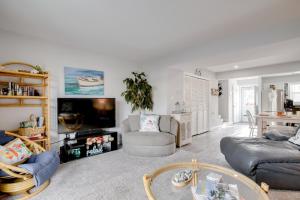 a living room with a couch and a tv at Remodeled Ocean City Getaway with Harbor Views! in Ocean City
