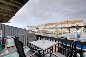a balcony with a table and chairs and a marina at Remodeled Ocean City Getaway with Harbor Views! in Ocean City