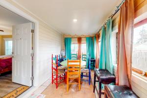 a room with a table and chairs and a window at Betty's Beach House in Galveston