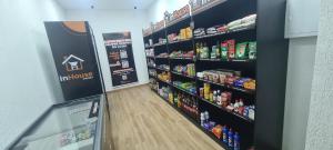 a store aisle with shelves of food and drinks at Flat Pasárgada 812, Free Bikes, pé na praia in Vila Velha