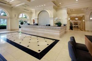 a large lobby with a hair salon with a checkerboard floor at Hilton Naples in Naples