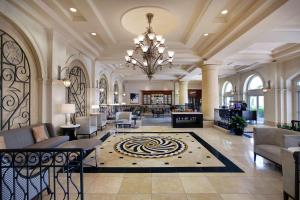 a lobby of a hotel with a chandelier at Hilton Naples in Naples