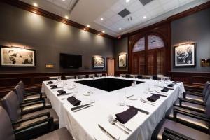 a conference room with a long table and chairs at Hilton Naples in Naples