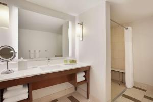 a bathroom with a sink and a mirror at Hilton Naples in Naples