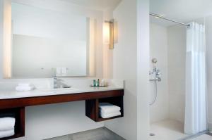 a bathroom with a sink and a shower at Hilton Naples in Naples