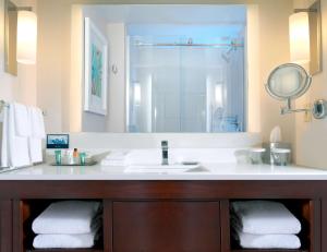 a bathroom with a sink and a mirror at Hilton Naples in Naples
