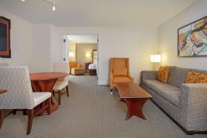 a living room with a couch and a table at Hilton Naples in Naples