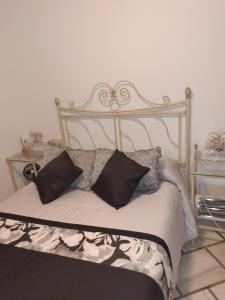 a bed with a metal frame with pillows on it at Mccoy avenida 3 in Macael