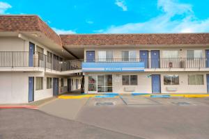 a building with a parking lot in front of it at Motel 6-Farmington, NM in Farmington