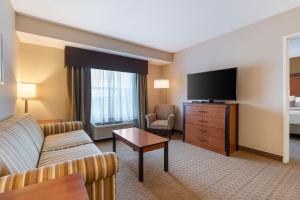 a living room with a couch and a flat screen tv at Best Western Bend North in Bend