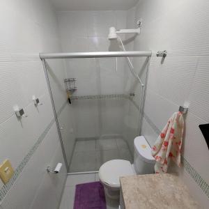 a white bathroom with a shower and a toilet at FLAT GRAVATÁ WINTERVILLE 1214 in Gravatá