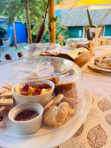 a plate of food with bread and fruit on a table at Altillo Valizas in Barra de Valizas