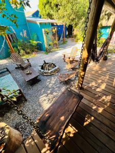a patio with a swing and a dog sleeping on a dog bed at Altillo Valizas in Barra de Valizas