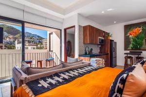 a bedroom with an orange bed and a balcony at Madero 320 - 310 in Puerto Vallarta