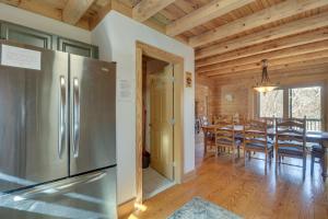 a kitchen and dining room with a stainless steel refrigerator at Big Bear Lodge - Cabin in Massanutten Resort! in McGaheysville