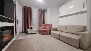 a living room with a couch and a chair at Cosy and stylish studio in Bucharest