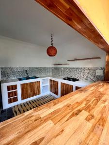 a kitchen with a wooden counter and a wooden floor at Colonial Beach Airport Hotel in Cartagena de Indias