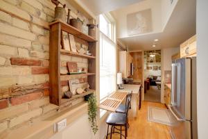 a brick wall in a kitchen and a living room at Updated Apt 1 Block to Water St and Kalamazoo River in Saugatuck