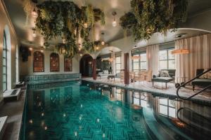 a large swimming pool in a building with a large at Lejondals Slott in Bro