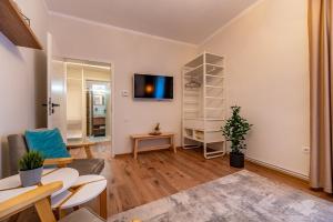 a living room with a tv on a wall at Apartment Balcescu No 10 in Sibiu