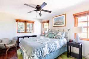 a bedroom with a bed and a ceiling fan at The Little Pumpkin Guest House in San Diego